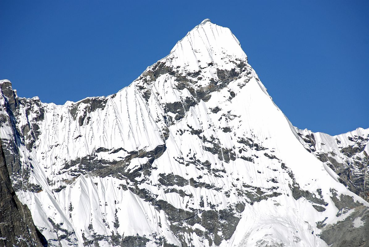 17 Triangle Close Up As Trek Nears Shishapangma Advanced Base Camp Triangle Peak (6600m) is the triangular summit on the wall between Pemthang Karpo Ri and Pemthang Ri (6842m), seen as the trek nears Shishapangma Southwest Advanced Base Camp.